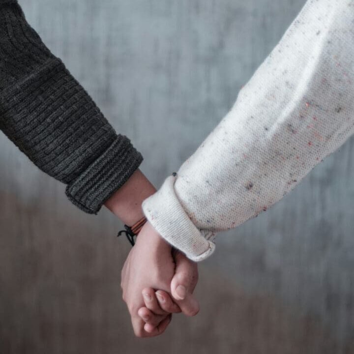 two people holding hands